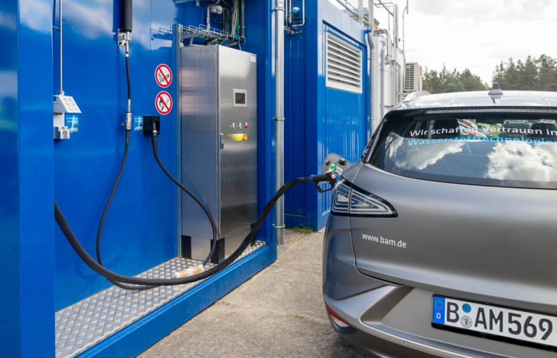 Image of the refueling station with a car being charged at the pump.