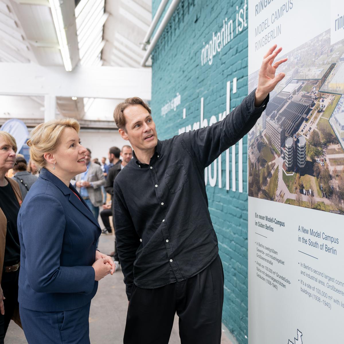 ChatGPT: Standing in front of a wall visualizing the pop-up of the Berlin Innovation Center for Crafts (BIZH) are Carola Zarth, President of the Berlin Chamber of Crafts; Franziska Giffey, Senator for Economics, Energy and Public Enterprises, Berlin; and Matthias Menger, Managing Director of ringberlin/KOIMO Development.