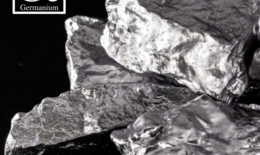 Silver fragments of the semiconductor material germanium and the image of the element with the letters GE from the periodic table.