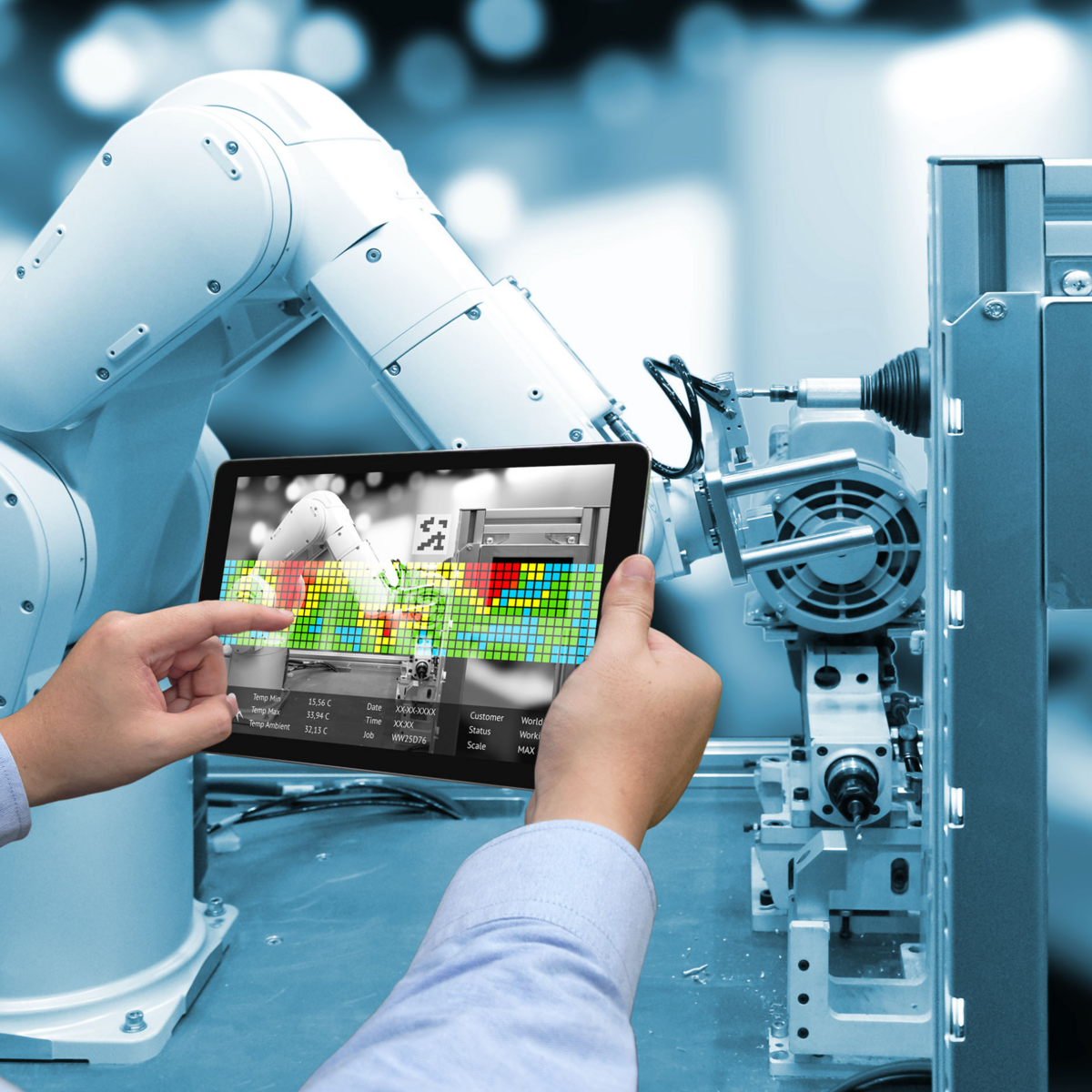 Picture shows a robotic arm and two human hands holding a control panel and controlling the robotic arm. The whole thing is in a factory-like environment. It picks up on robotics as a theme, which plays a role in the article text.