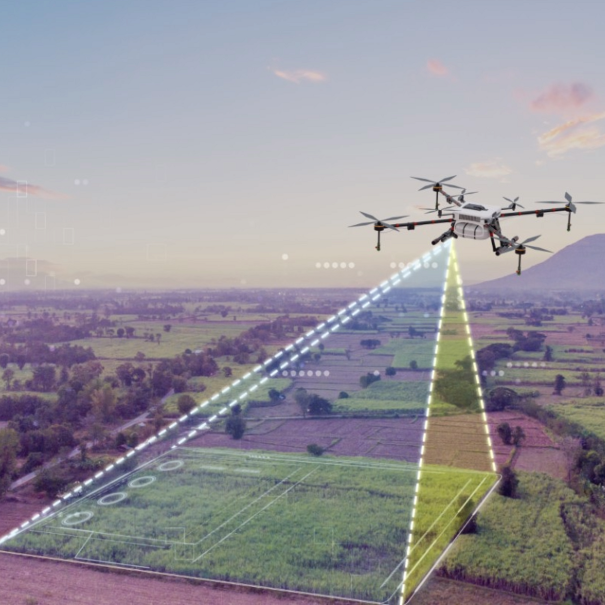 Picture shows an aerial view of a landscape. You can see a drone in the air. An animation of dashed lines and colored areas makes it clear that the drone is surveying the area below it.