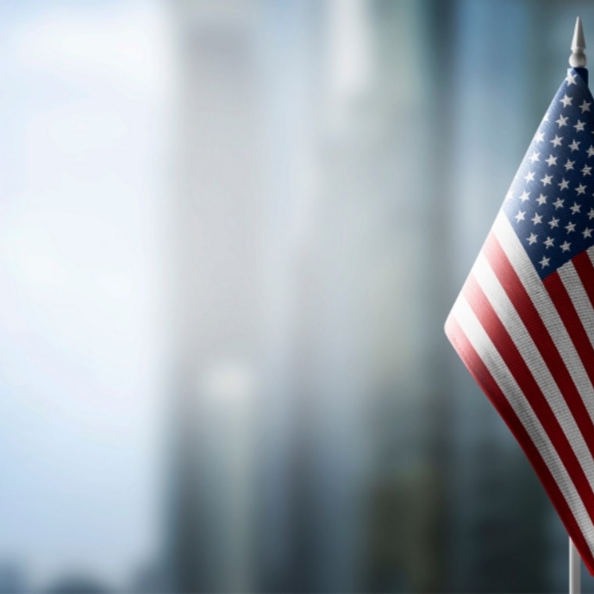 Flag of USA in foreground, background blurred building