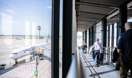 Passengers on their way through the jet bridge to the United aircraft at Berlin Brandenburg Airport